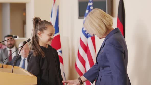 Female Politician Talking to Little Eco Activist at Conference