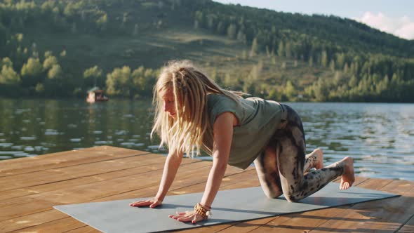 Woman Practicing Yoga on Lake Dock