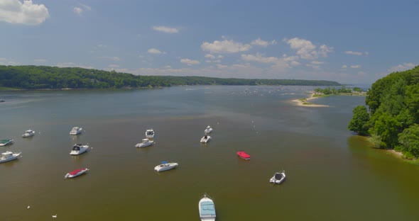 Flying Over Anchored Boats on Harbor Near a Forest on a Sunny Day