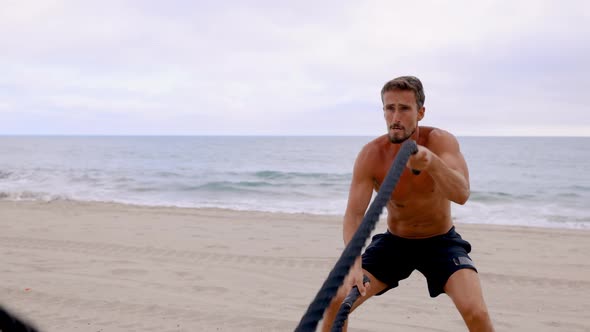 Athletic Man Exercising At The  Beach