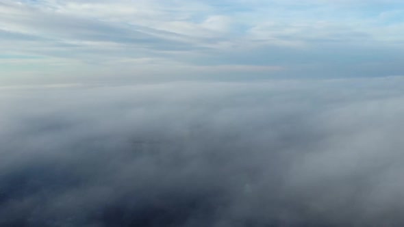 Aerial Drone View Flight Over Above Fog Mist and Roofs of Buildings in City