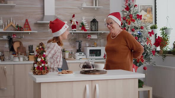 Grandmother and Granddaughter Bringing Xmas Wrapper Present Gift with Ribbon on It