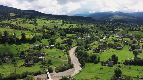 Carpathian Mountains with River and Wooden Houses