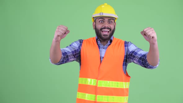 Happy Young Overweight Bearded Indian Man Construction Worker Getting Good News