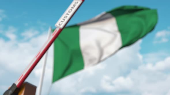 Closing Boom Barrier with CUSTOMS Sign at the Flag of Nigeria