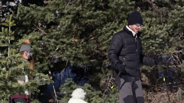 Couple hiking through forest as they stop to look at the scenery