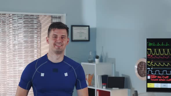 Close-up of Handsome Athlete Walking on Treadmill and Smiling