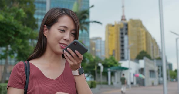 Woman use of mobile phone online at outdoor