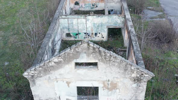 Roofless derelict building abandoned after hurricane: walls of demolished and dilapidated house