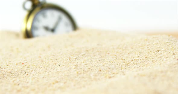 Alarm clock in sand