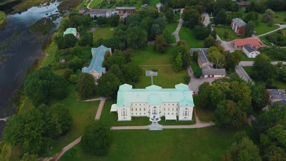 Aerial Shot City Mezotne, Latvia Republic. Mezotne Palace and Park With Fountain. Lielupe River With