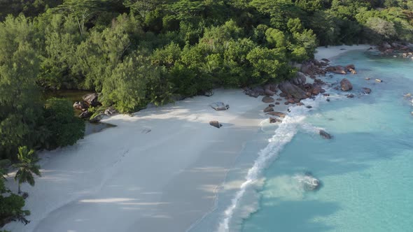 Aerial view of a person walking on the beach of Anse Lazio, Seychelles.