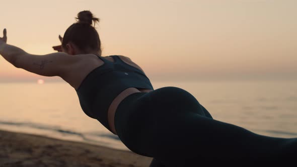 Fit Girl Practicing Yoga Pose on Beach