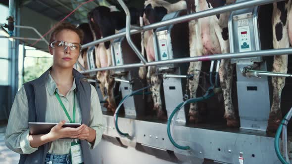 Serious Woman Dairy Farm Worker Pose in Parlour