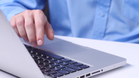 Man's Hand Holds a Credit Card While Entering Data in Laptop. Close Up