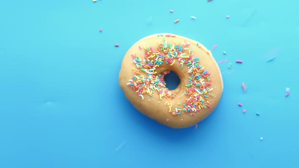 Colorful Donuts on Blue Background Top Down