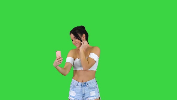 Beautiful Young Woman Doing Selfie on a Green Screen, Chroma Key