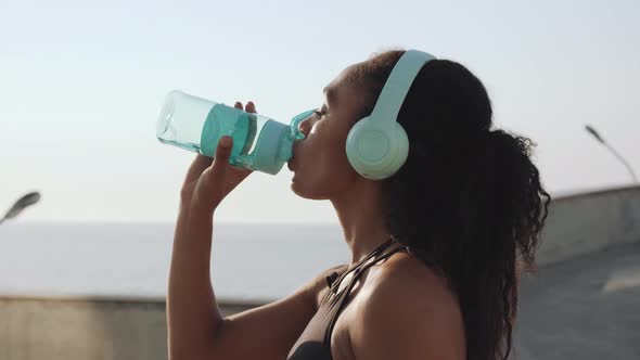 An attractive american woman drinking water