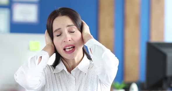 Woman Covers Ears with Her Hands and Shakes Head