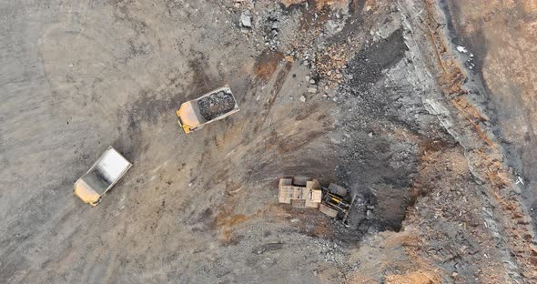 Excavator Loads Stone Gravel Into a Truck on a Crushed Stone Quarry