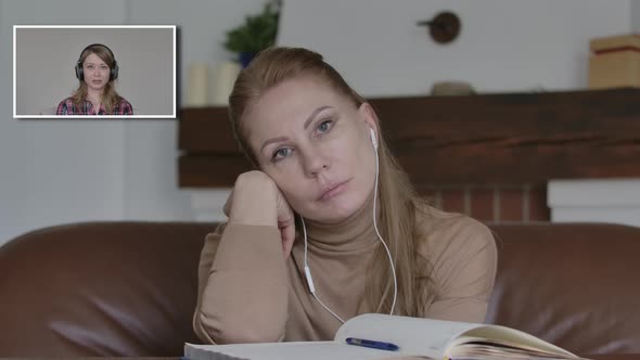 Unhappy Caucasian Woman Listening To Boring Colleague Talking in Video Chat and Yawning. Portrait of