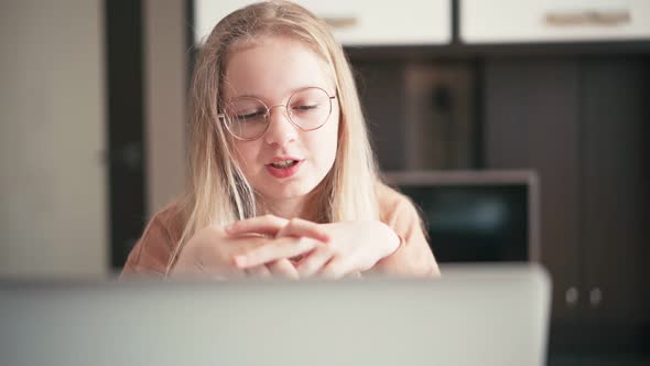 Beautiful 10 Years Old Girl in Glasses Having a Video Chat with Her Teacher