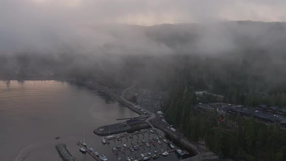 Aerial View of a small secluded town on the Pacific Ocean Coast during a cloudy summer sunrise. Take