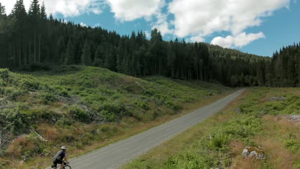 Cyclist Ride Up Beautiful Forest Gravel Road