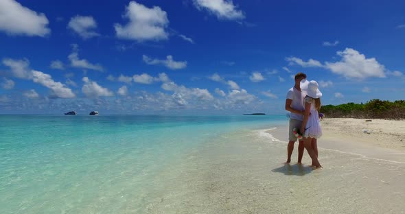 Young couple in love dating on vacation live the dream on beach on paradise white sand background 4K