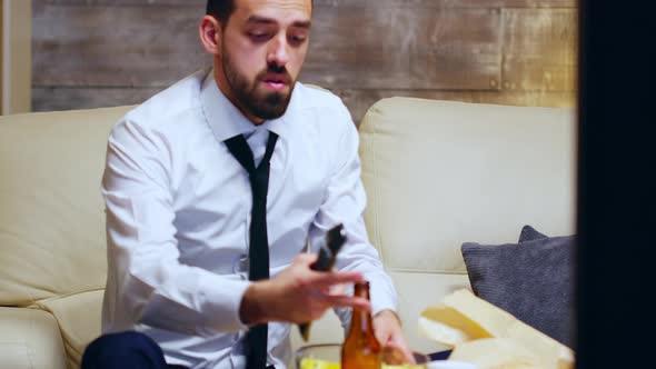 Overworked Businessman Sitting on Couch