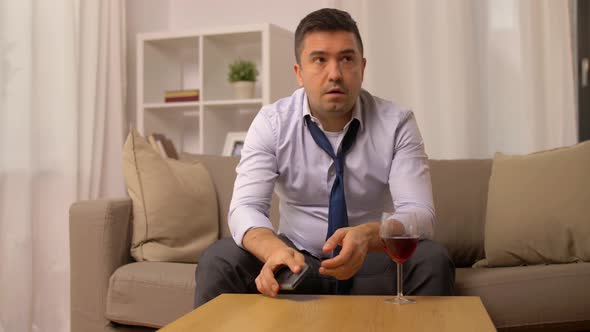 Alcoholic with Smartphone Drinking Wine at Home