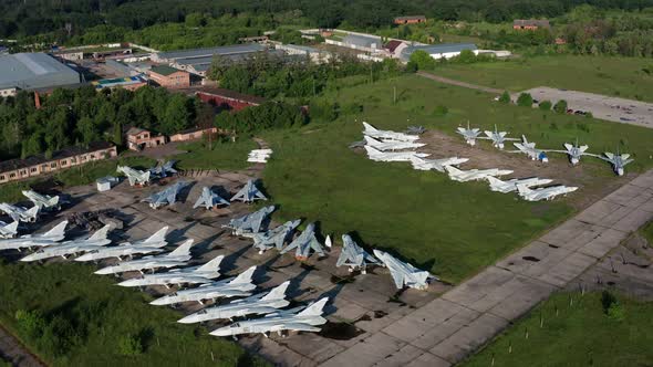 Top view of the planes at the airfield. Many old, broken aircraft are at the airfield. alt