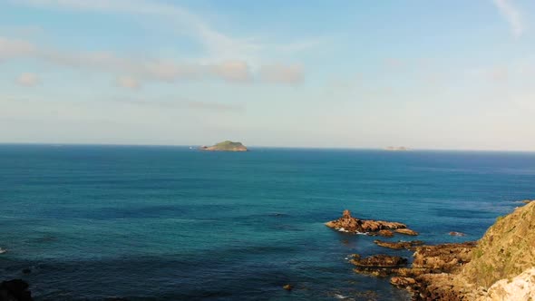 Slowdown aerial shot of the water by the cliff. Ocean. Quy Nhon, Vietnam.