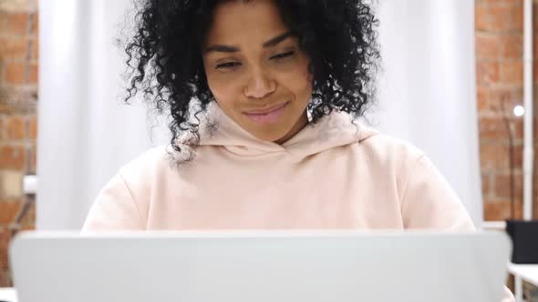 Smiling Positive AfroAmerican Woman Working on Laptop