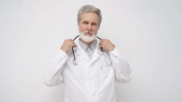 Confident Elderly Male Doctor in White Medical Uniform