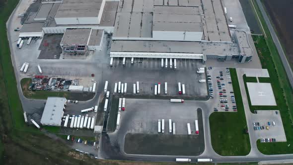 Industrial zone on the field. Roofs of modern plant with parking places. 