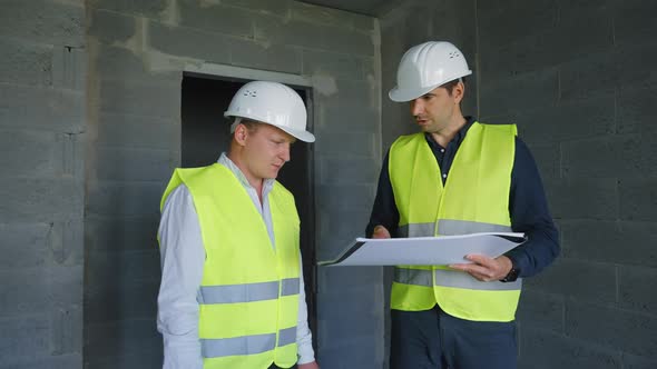 Architect and Foreman Discussing Project at Construction Site