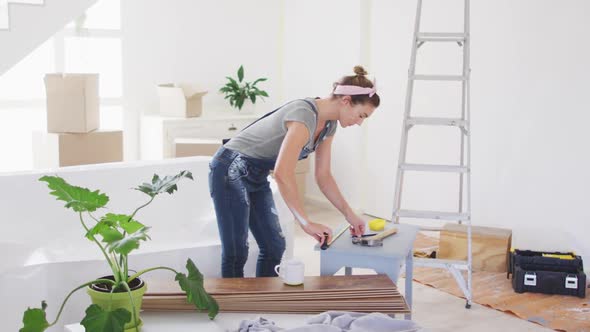 Portrait of a Caucasian woman in quarantine during coronavirus pandemic, doing interior work