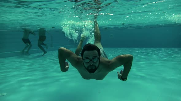 Male Relaxing Leisure In Swimming Pool Luxury Hotel Spa. Man Swimming Underwater. Holiday Trip.