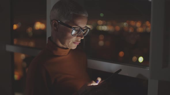 Business Lady Using Smartphone in Dark Office