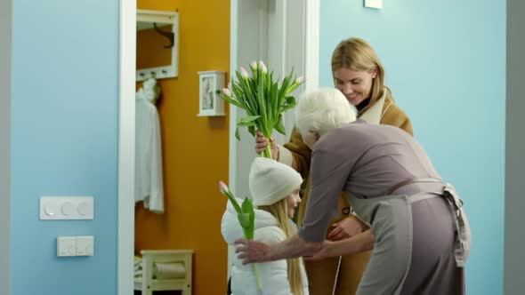 Grandmother Meeting Family Members at Home