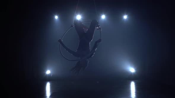 Aerial Acrobat in the Ring. A Young Girl Performs the Acrobatic Elements in the Air Ring in the