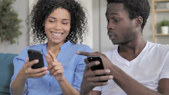 African Couple Sharing Information on Smartphone
