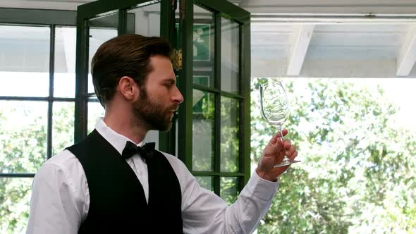 Waiter examining a empty wine glass