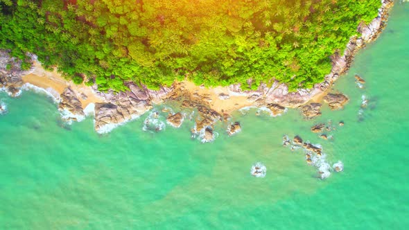 Aerial Top views over beaches, ocean waves crashing on rocks and sand