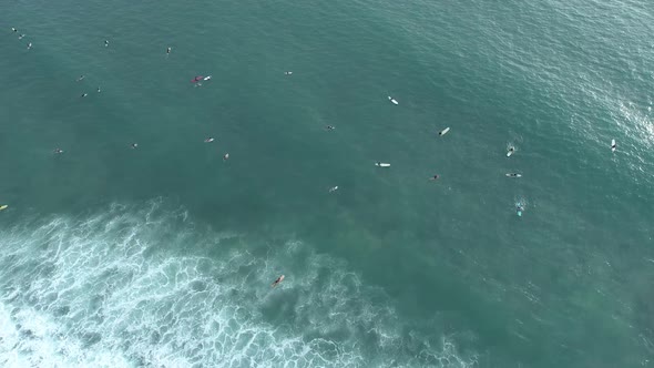 Top down of waves break on tropical sea Surfers with surfing boards