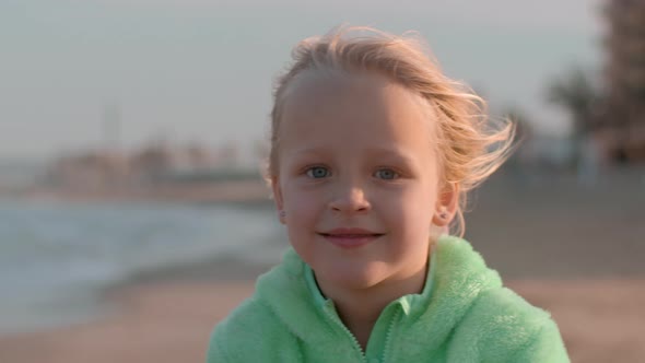 Portrait of a Little Happy Girl on the Beach