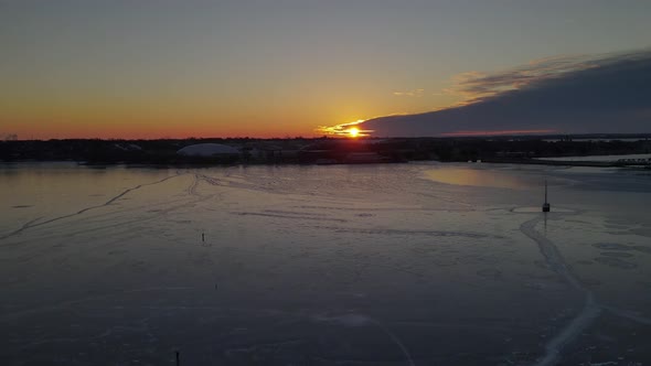 aerial  over a frozen lake during sunrise