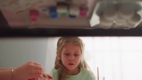 Little Girl Looks at Sister Dripping Paint for Ebru Design