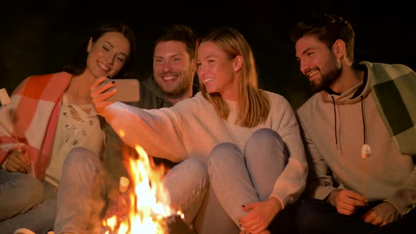 Friends Taking Selfie at Night Camp Fire